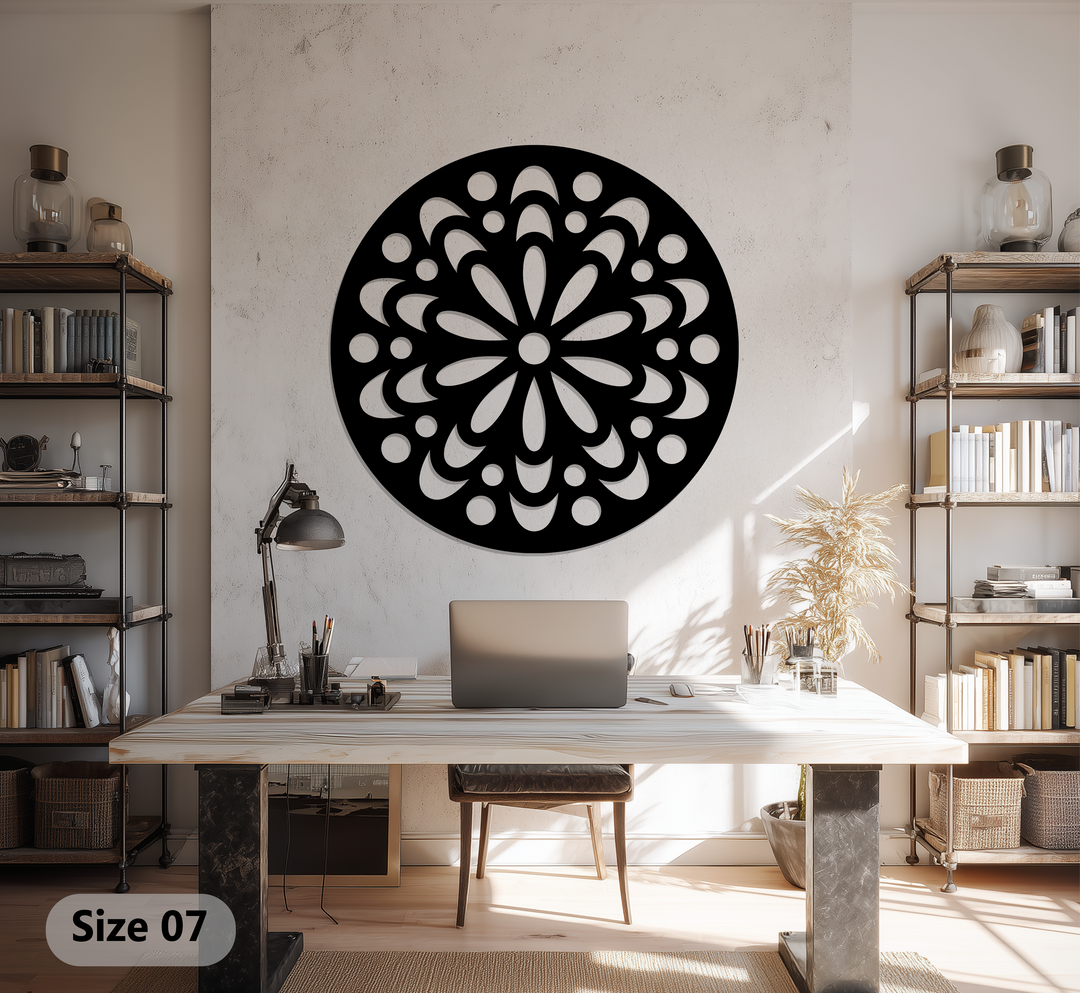 Horizontally oriented, round decorative metal art displays an ornamental floral mandala pattern cut from black metal.