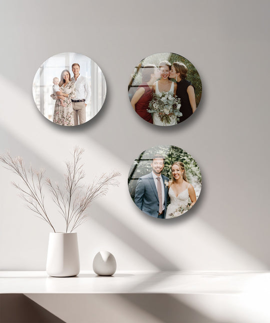Round glass wall art features family and wedding photos and personalized elegance and is modern home decor and a custom photo gift on a white wall