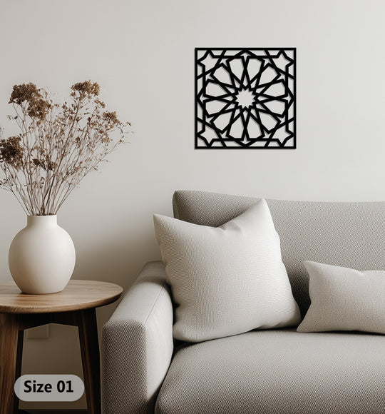 Black dominates the view of this square geometric star pattern Islamic metal art for wall design, displayed above a neutral couch.