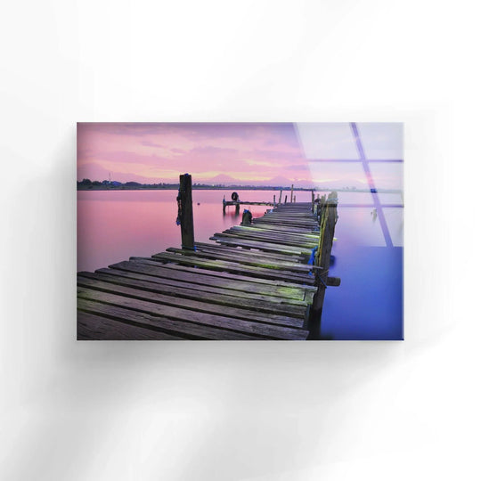 Showcasing the clean edge and borders of this abandoned dock at sunrise glass wall art, adding an elegant touch of home decor to any space.