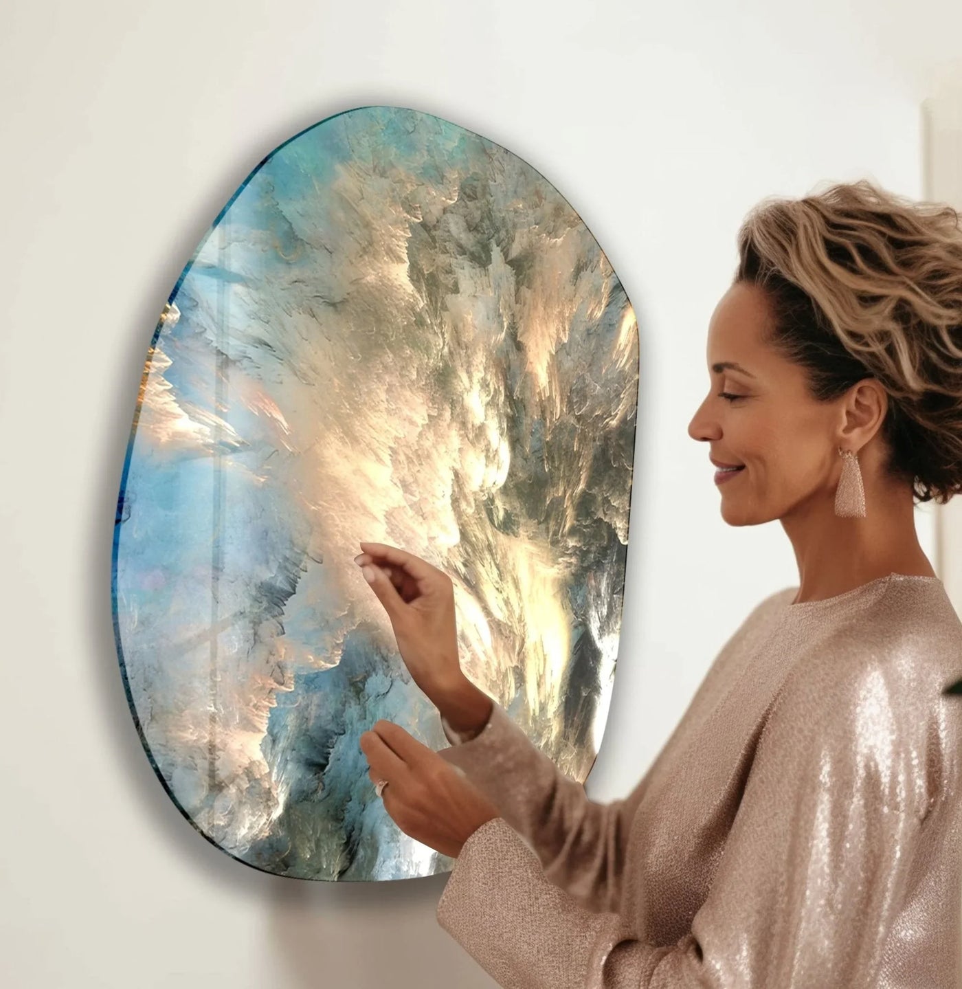 A woman admires the shimmering, iridescent edge of an abstract blue aesthetic glass art painting.