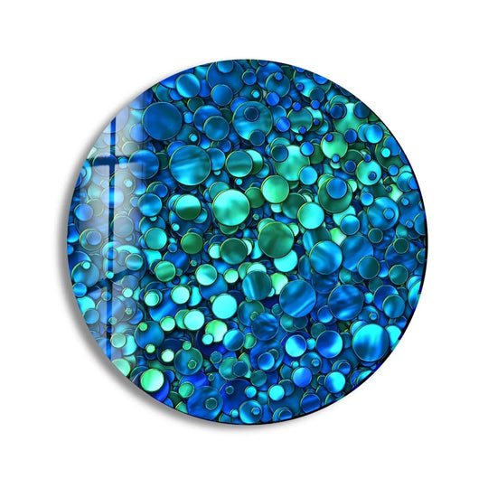The softest element is a light iridescent sheen across this abstract blue bubbles decorative wall art, creating a tranquil and modern round glass wall art piece.