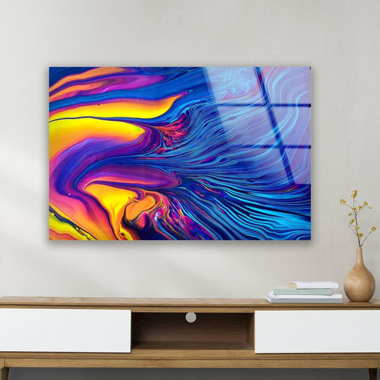 Vibrant layered swirls of blue and orange flow across this glass hanging wall art.
