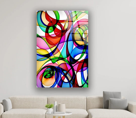 This large abstract glass art showcases a vibrant, multi-colored finish with overlapping geometric shapes and smooth, glossy highlights.