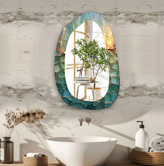 An asymmetric glass wall mirror with an abstract cracked design in blue teal and gold reflecting a modern bathroom interior