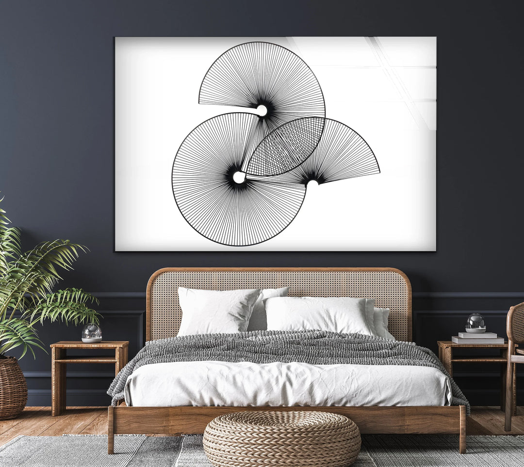 Minimalist wall art featuring three black spiral designs.