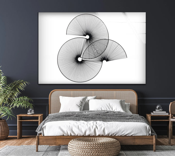 Minimalist wall art featuring three black spiral designs.