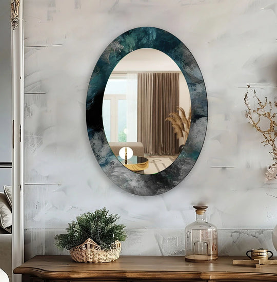 An asymmetric mirror with an abstract dark teal and gray design an oval wall mirror and a decorative accent mirror on a textured wall