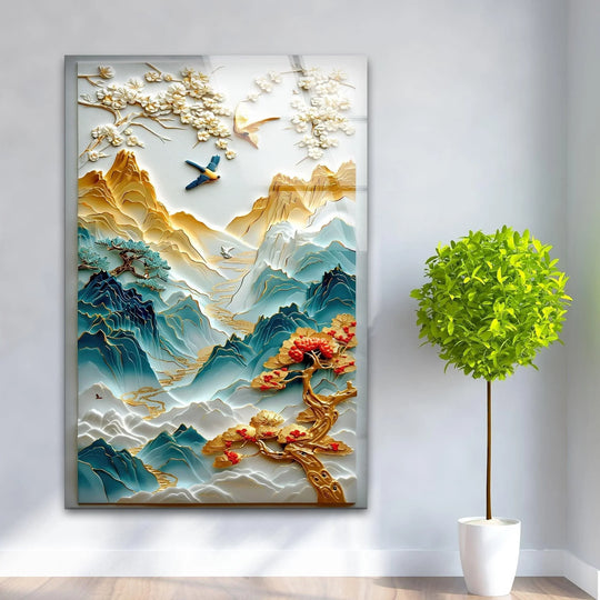 Vertical rectangular tempered glass wall art features an abstract landscape painting with golden mountains, teal ridges, and delicate blossoming trees.