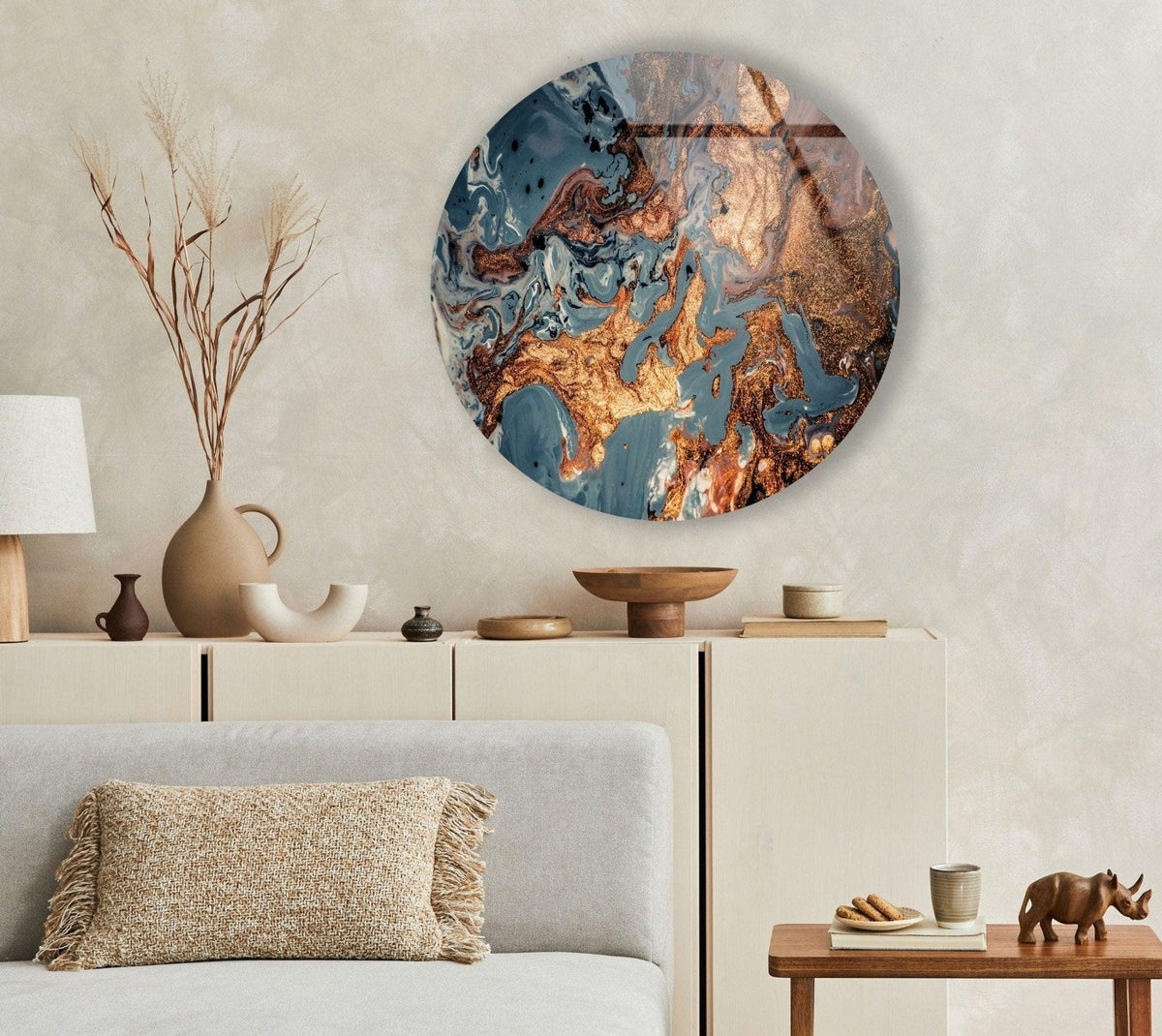 The stillness of the room is accentuated by the abstract round copper art from glass wall decor above the muted sideboard.