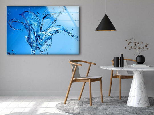 Horizontal rectangular glass art painting displays an abstract blue flower splash design.
