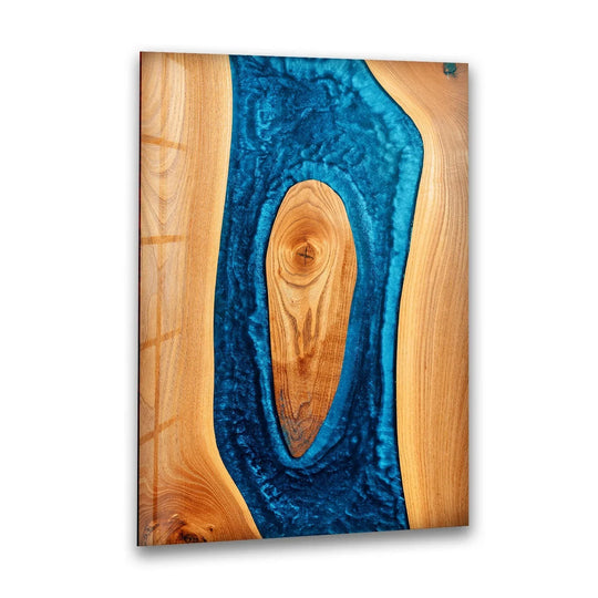 Rectangular art from glass features a vertical orientation with an irregular blue epoxy river flowing through natural wood.