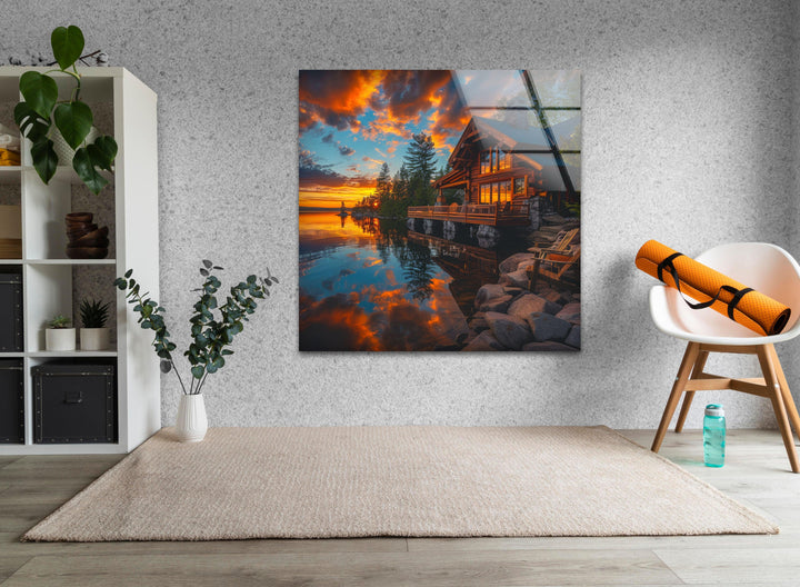 High-quality glass print capturing a cozy wooden cabin by the water.
