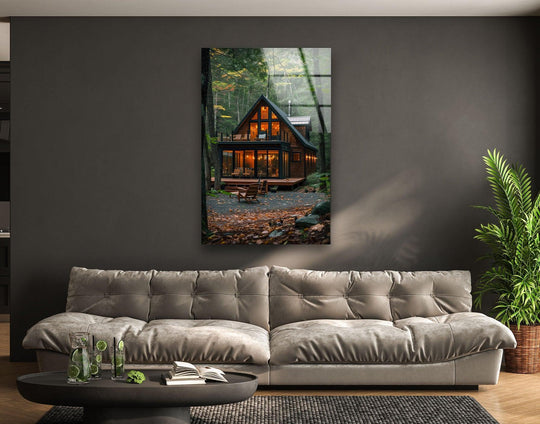 The stillness of the forest envelops a cozy cabin, reflected in the glass wall art prints that capture a tranquil woodland scene.