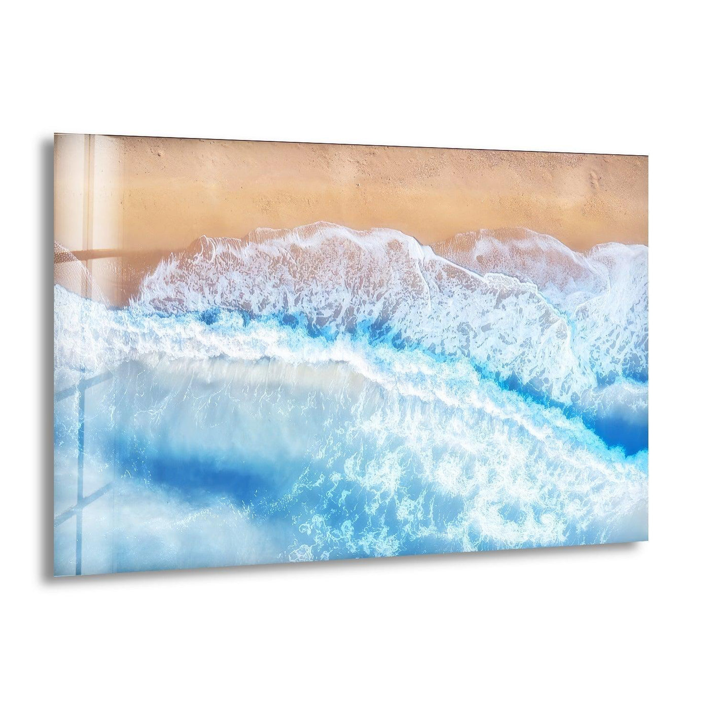 Foaming ocean surf displays its gentle ebb and flow as the softest element in this aerial view beach hanging wall art.