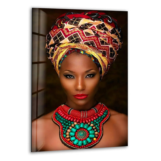An African woman's vibrant headwrap and beaded necklace showcase a rich transition between fiery reds, warm yellows, and striking turquoise in this tempered glass wall art.