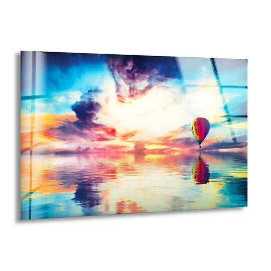 Visual rhythm repeats the shapes of a hot air balloon and vibrant sky in this landscape air balloon landscape glass wall artwork, mirrored in the water below.