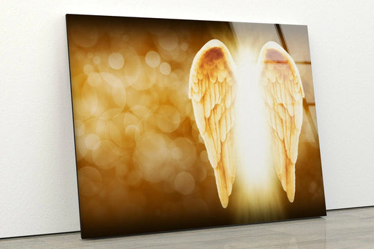 Darkest areas of a glass art piece feature glowing angel wings against a warm, bokeh background.