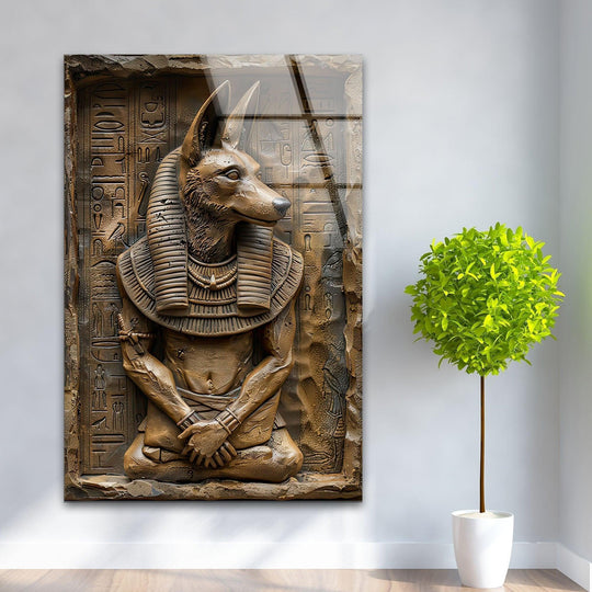 Serene glass wall artwork captures the ancient stillness of a bronze Anubis statue in contemplative repose.