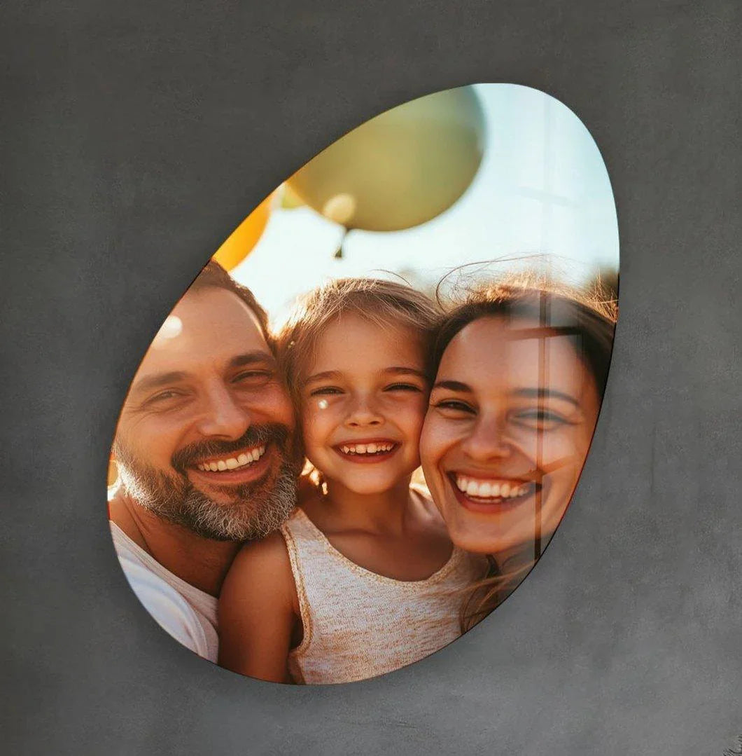 Custom oval glass art featuring a smiling family captured with a glossy, reflective finish.