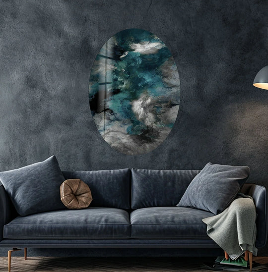 Oval abstract smokey glass wall art featuring turbulent teal, white, and grey swirls as the central subject.
