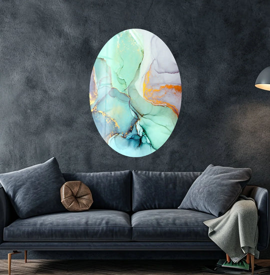 An oval turquoise marble glass wall art print features swirling abstract patterns with realistic metallic gold accents.
