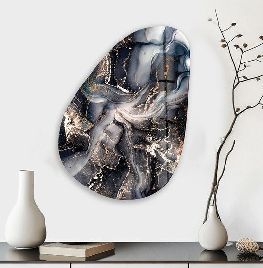 An asymmetrical oval black grey marble art from glass is set against vast negative space.