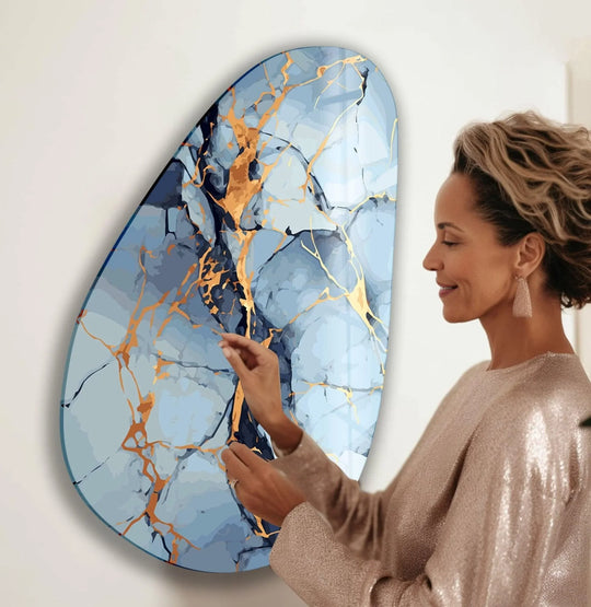 Abstract oval light blue glass wall art with a striking layering effect, featuring marbled blue and gold accents, ideal as wall prints.