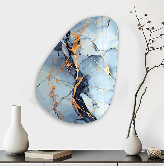 An asymmetrical oval light blue abstract glass wall art decor with marbled textures and golden veins.