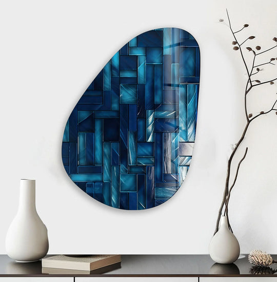 Deep navy blues and bright azure hues create a striking color contrast in this abstract asymmetrical oval decorative wall art.