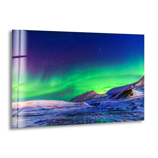 Gleaming Aurora Borealis landscape glass wall art decor conveys the kinetic energy of the celestial lights dancing over the tranquil, snow-covered mountains.