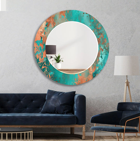 Green Abstract Copper Wall Mirror with a round design featuring vibrant teal and copper hues on a concrete wall for artistic home decor