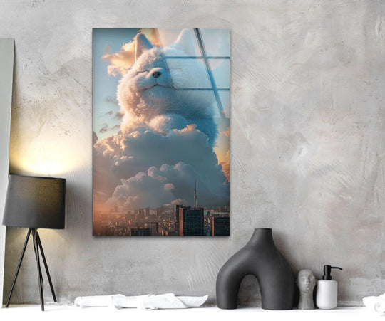 A massive white fluffy cat composed of geometric shapes rests on clouds above a city in this glass wall art.