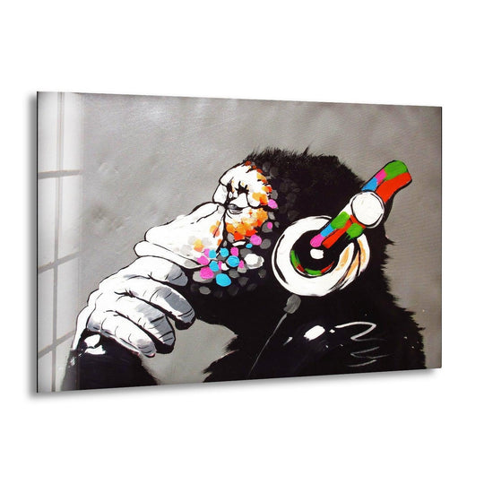 Banksy canvas wall art depicts a gorilla with headphones and colorful paint splatters and this urban decor features a thinking monkey and street art style