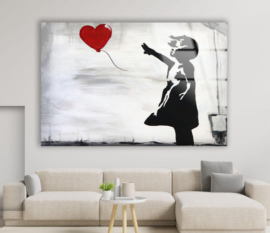 Banksy Girl with Balloon glass wall art is a large Banksy wall art piece with a black silhouette and red heart showing urban style