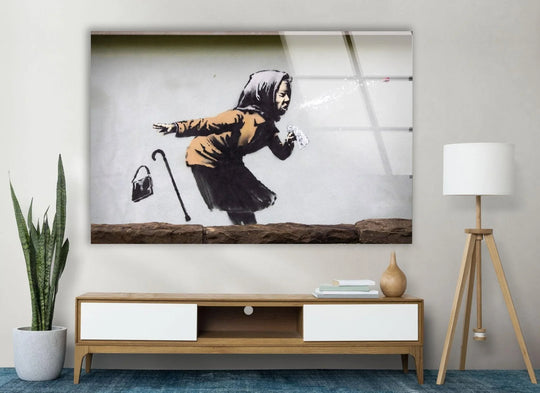 Banksy Sneezing Woman glass wall art depicting the famous street art graffiti with a brown jacket a great piece of Banksy wall art