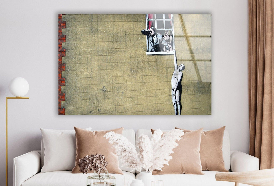 a living room with a white couch and a painting on the wall