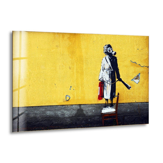 Banksy Woman with Gas Mask glass wall art shows the famous stencil on a yellow wall a large Banksy wall art print with urban style