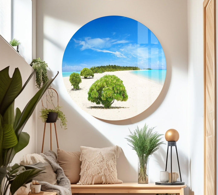 Relaxing nature-inspired glass wall art with a bright blue ocean and lush green trees.
