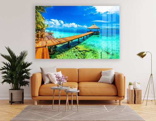 Layered turquoise waters recede in this beautiful paradise island glass wall artwork, creating a stunning sense of depth with the pier and distant shore.