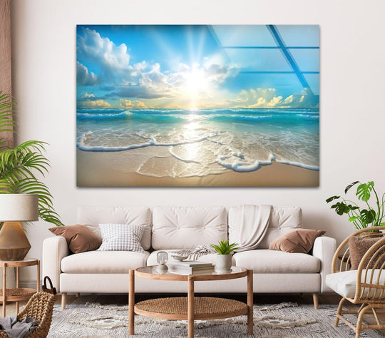 Landscape glass wall art depicts a beautiful sunset and ocean scene and this serene coastal decor evokes tranquil vibes and a sunny beach atmosphere on a white wall