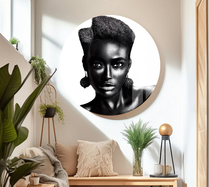 Minimalist black and white portrait of a woman with bold afro-inspired hairstyle.