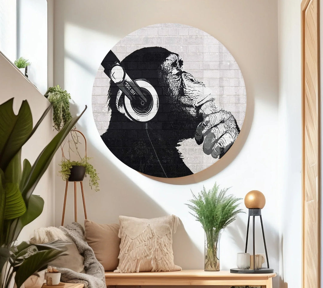 Monochrome artwork on glass showing a chimpanzee in a reflective pose while listening to music.