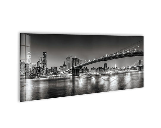 Brooklyn Bridge Black and White glass wall art showcases a city skyline and bridge lights reflecting on water and is modern wall decor for a large wall