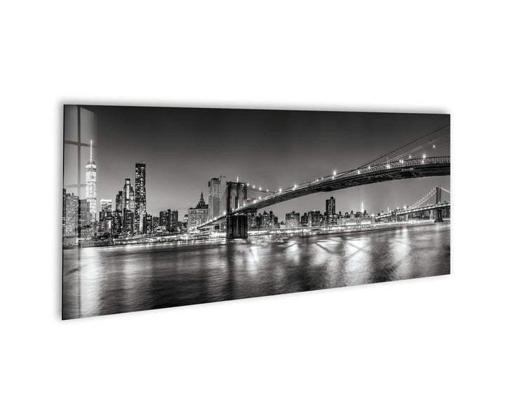 Black and white glass wall art featuring the Brooklyn Bridge and New York City skyline at night.