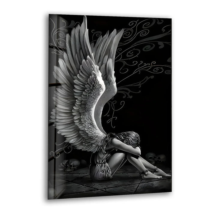 Black and white glass wall art featuring a sorrowful angel with large detailed wings sitting in a dramatic dark scene.