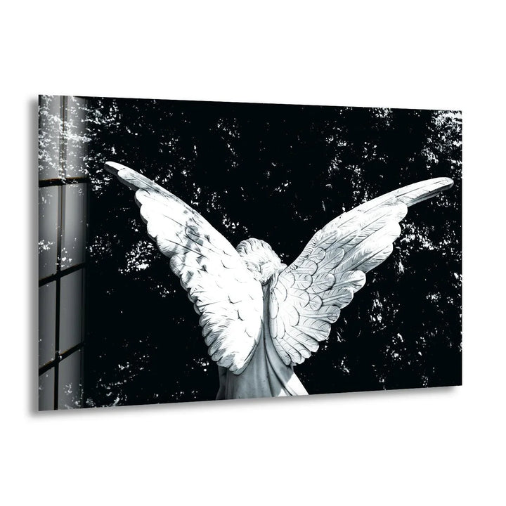 Black and white glass wall art featuring an angel figure with large outstretched wings against a dark textured background.
