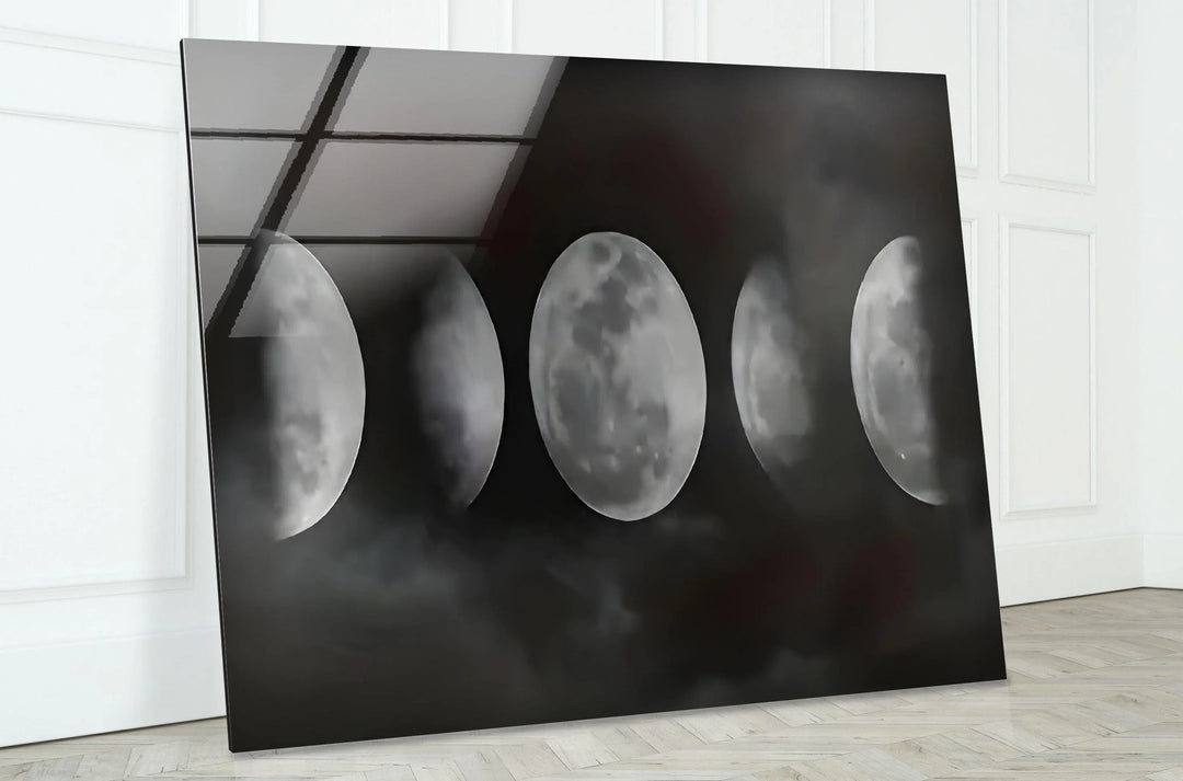 Lunar cycle glass wall art with soft cloud textures and bright moon details in black and white.
