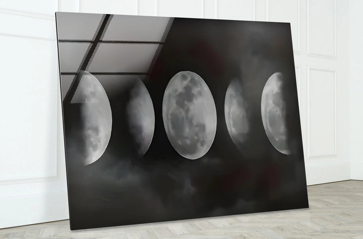 Lunar cycle glass wall art with soft cloud textures and bright moon details in black and white.