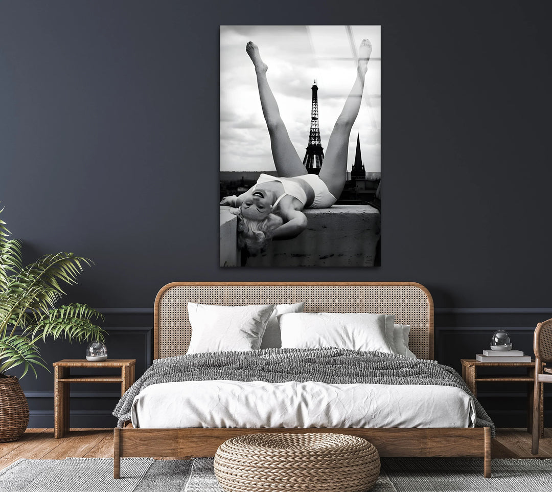 Paris rooftop scene in monochrome featuring a woman in a playful reclining position.